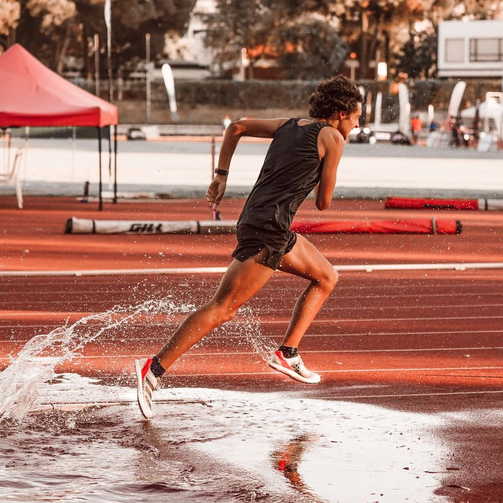 Track sprinter launching out of starting blocks in the Reign sprint kit.