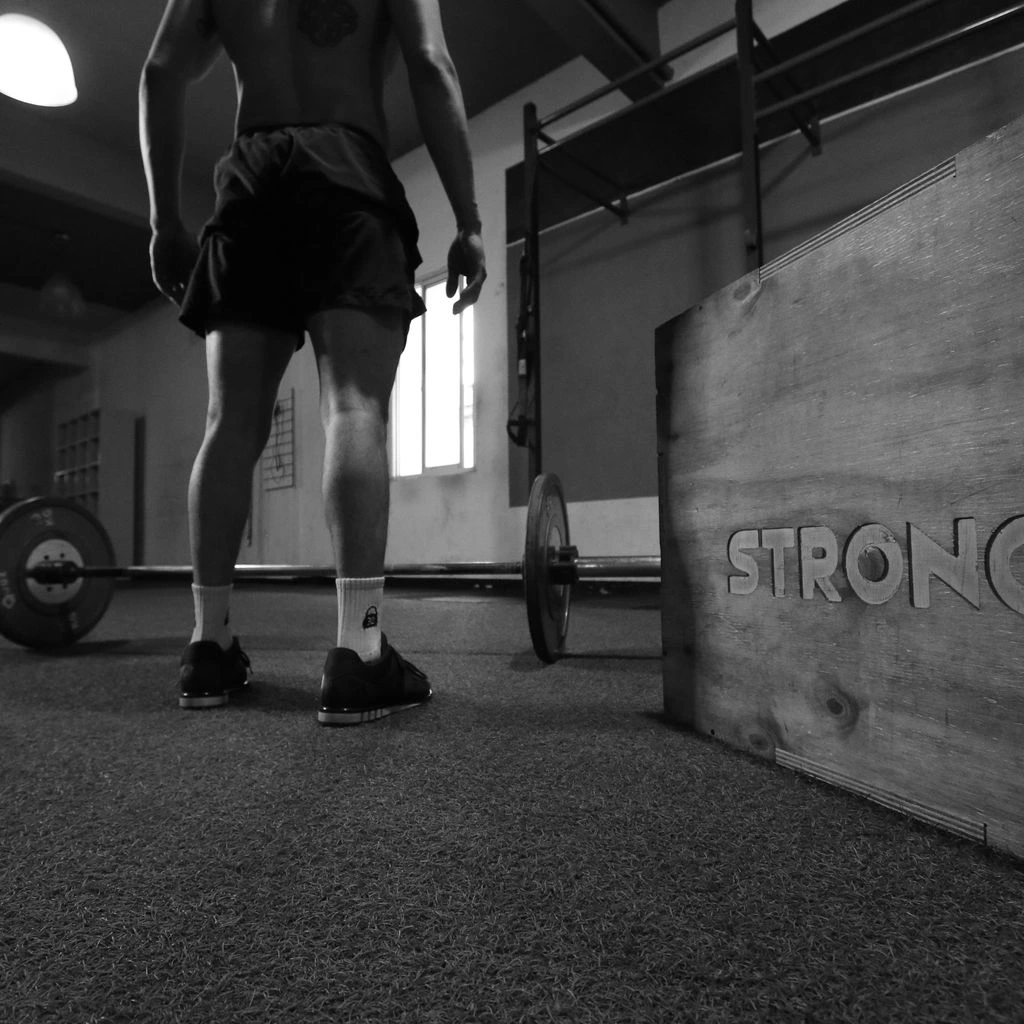 CrossFit athlete mid-box-jump wearing the Reign Heritage kit.